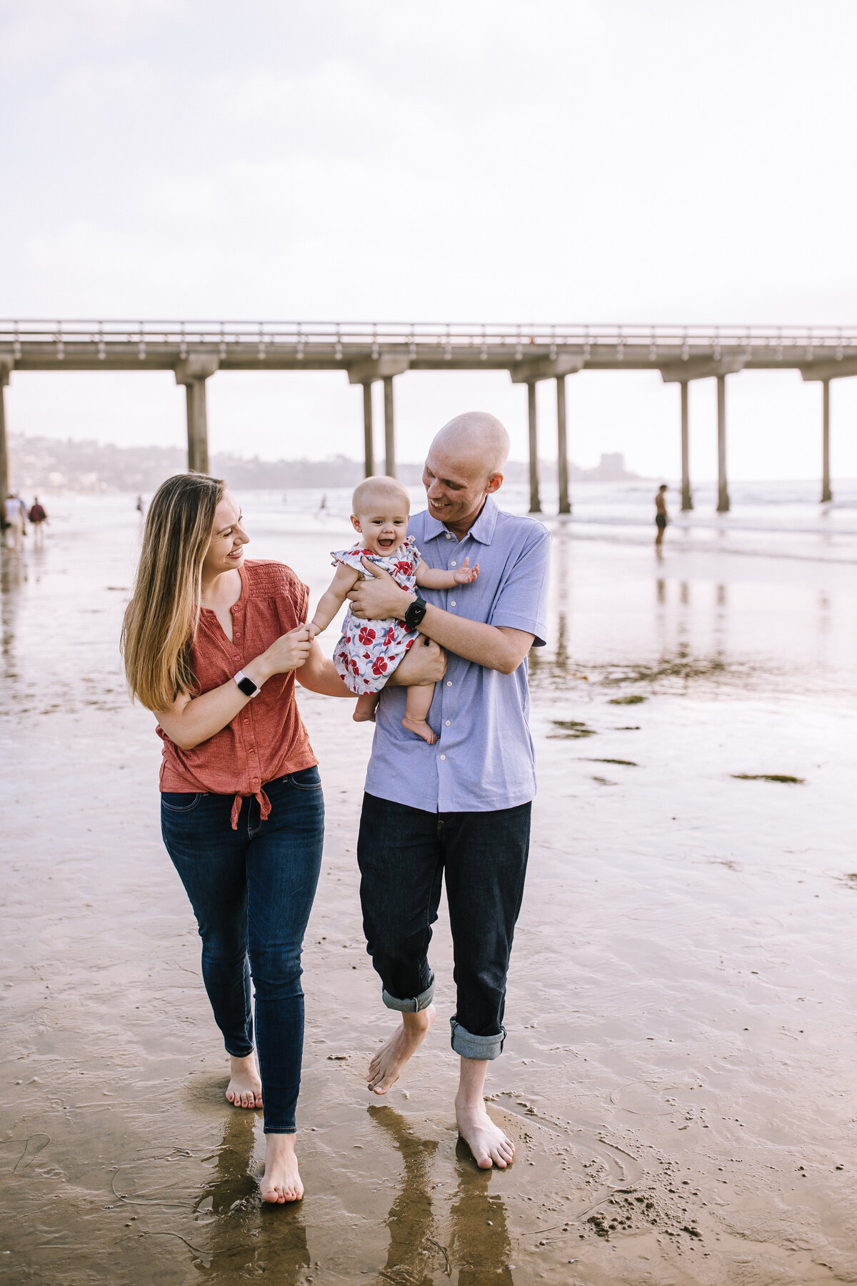 Family of three on the beach in San Diego, CA.