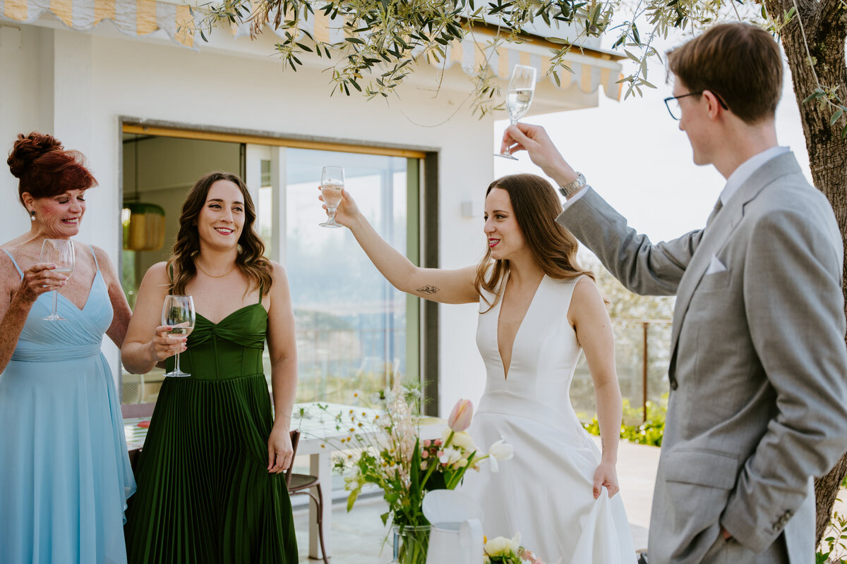 Friends celebrating with champagne on terrace