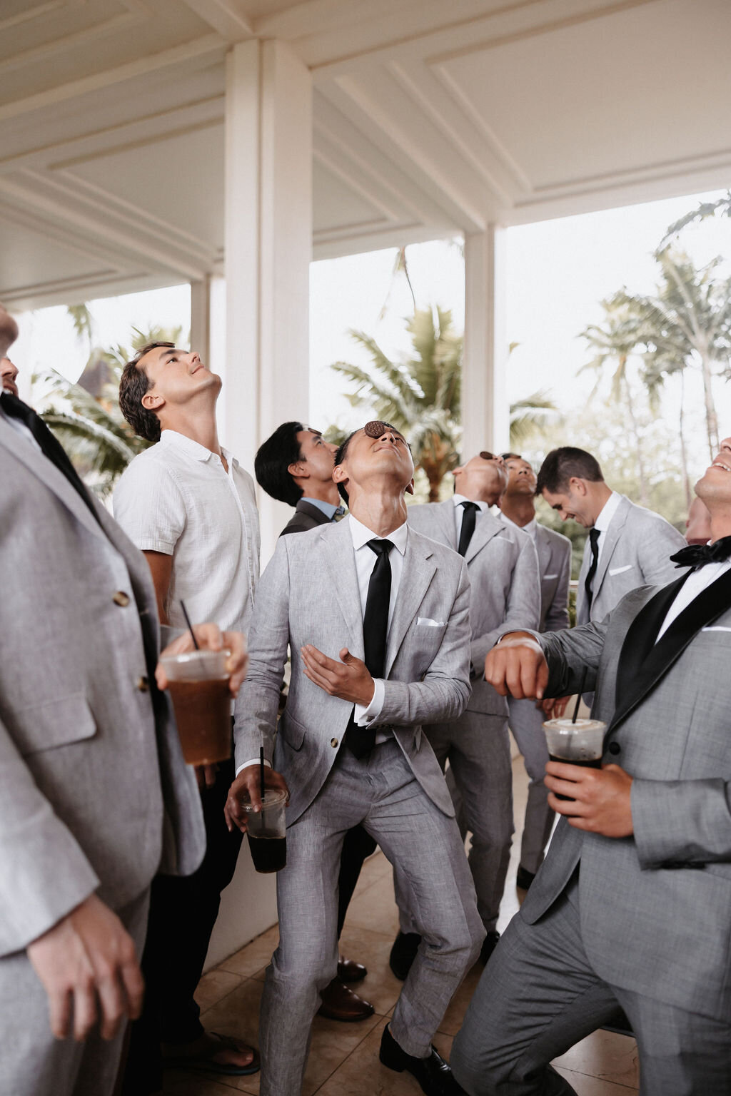 Chinese wedding game groom and groomsman balancing oreos on their face before wedding