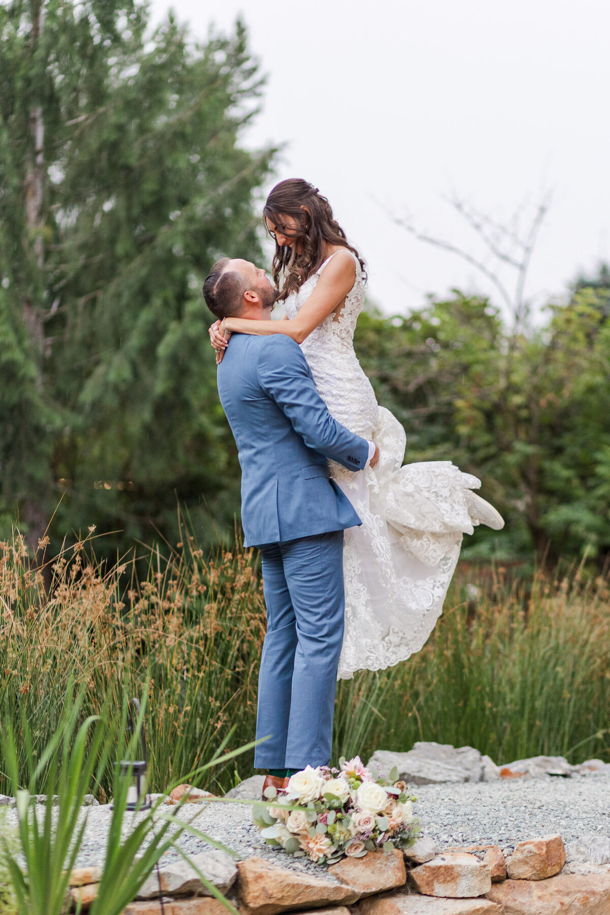 Groom-picks-up-bride-and-has-fun-at-stunning-forest-outdoor-venue-Gray-Bridge-Sultan-near-Snohomish-WA-photo-by-Joanna-Monger-Photography