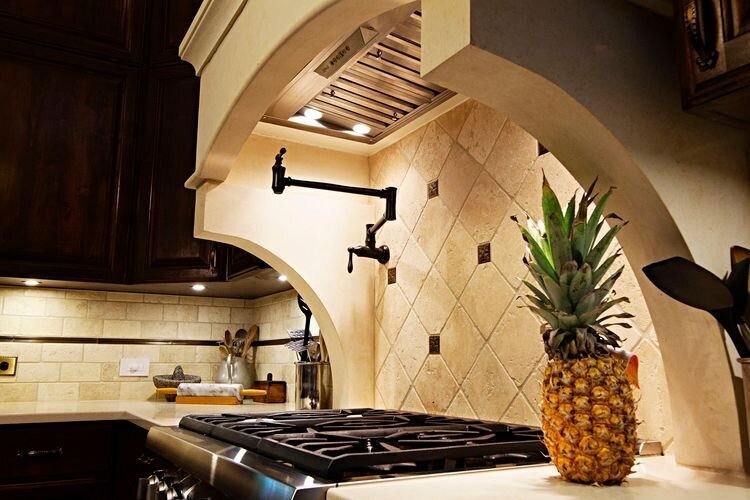 gas stove with modern tiled backsplash.