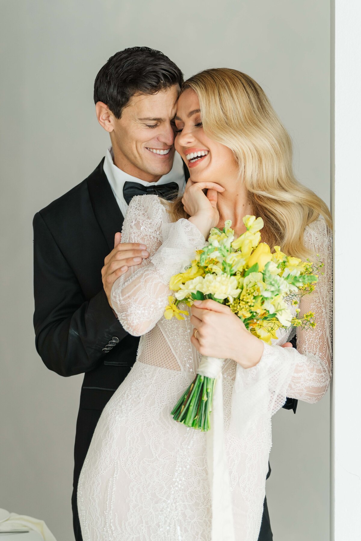 bride and groom miling at each other