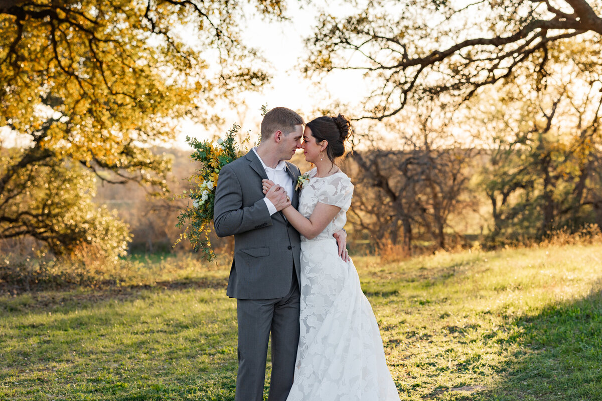 bride and groom holding each other at HighPointe Estate in Austin Texas by destination wedding photographer Amanda Richardson Photography