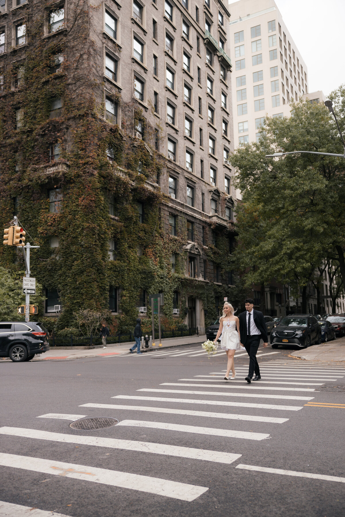 Elopement couple sharing a romantic moment in front of a brick building in NYC.