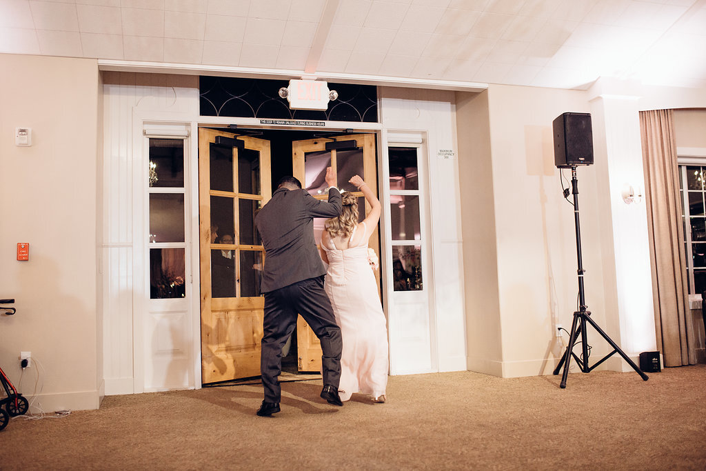 Wedding Photograph Of Groomsman And Bridesmaid Dancing At The Door Of The Reception Hall Los Angeles
