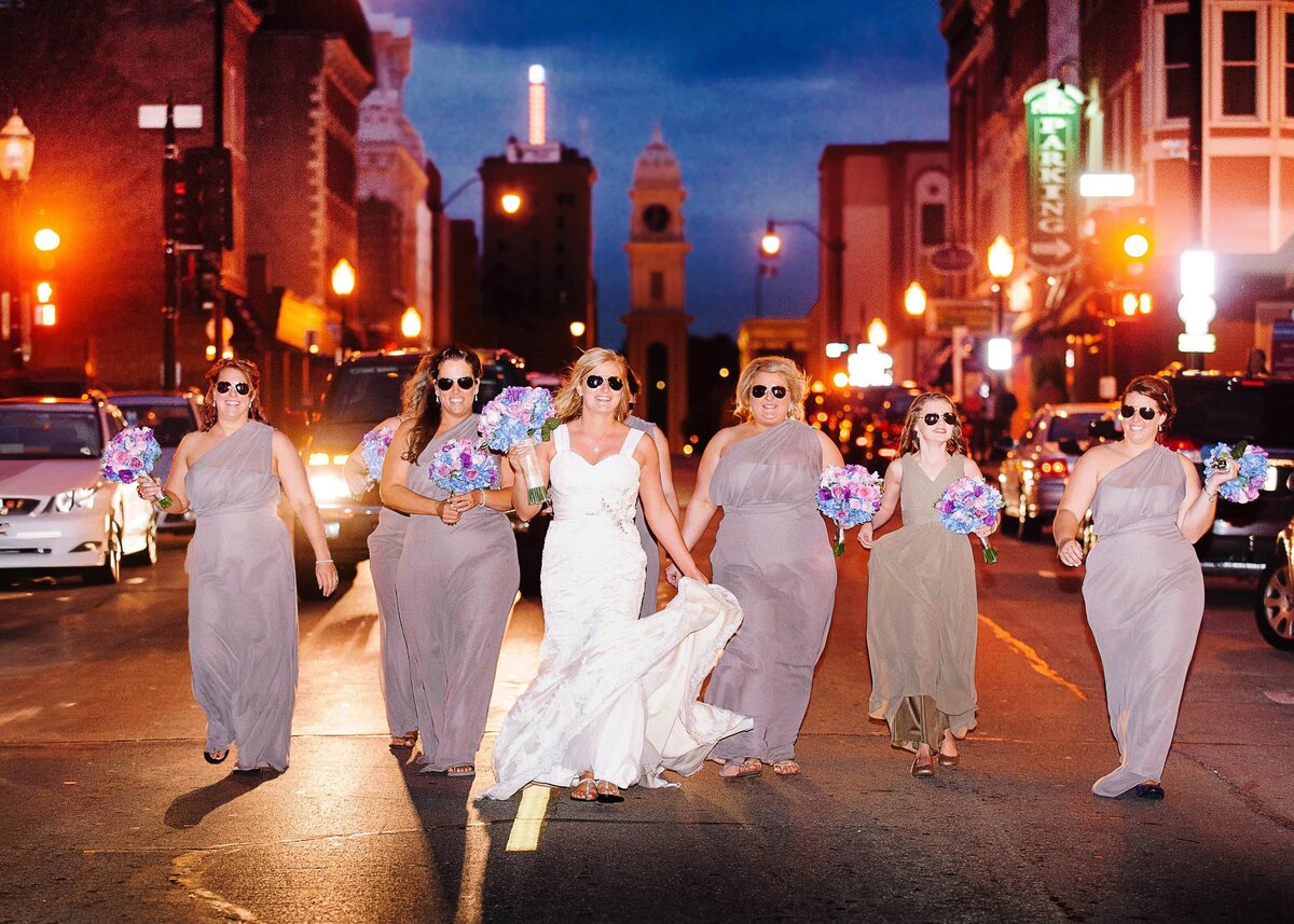 Bride with bridemaids walking main street Dubuque
