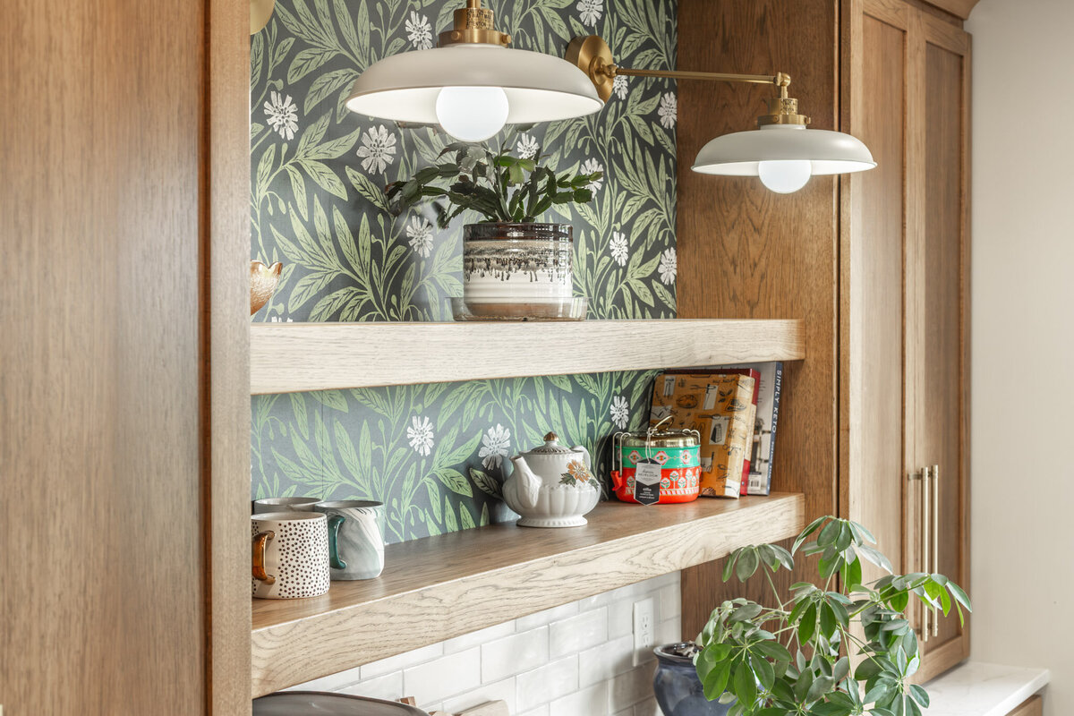 wood shelves and green floral wallpaper