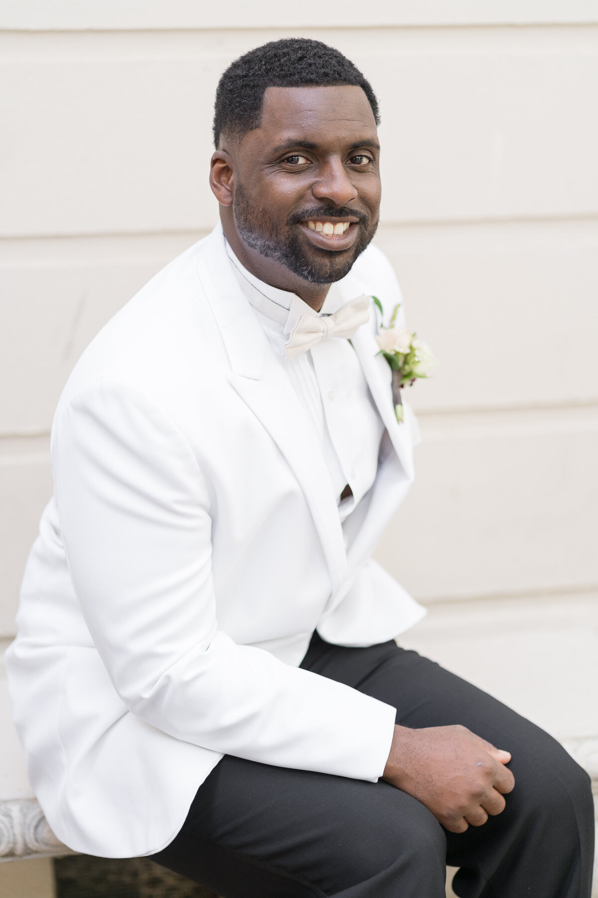 groom smiling and looking straight ahead