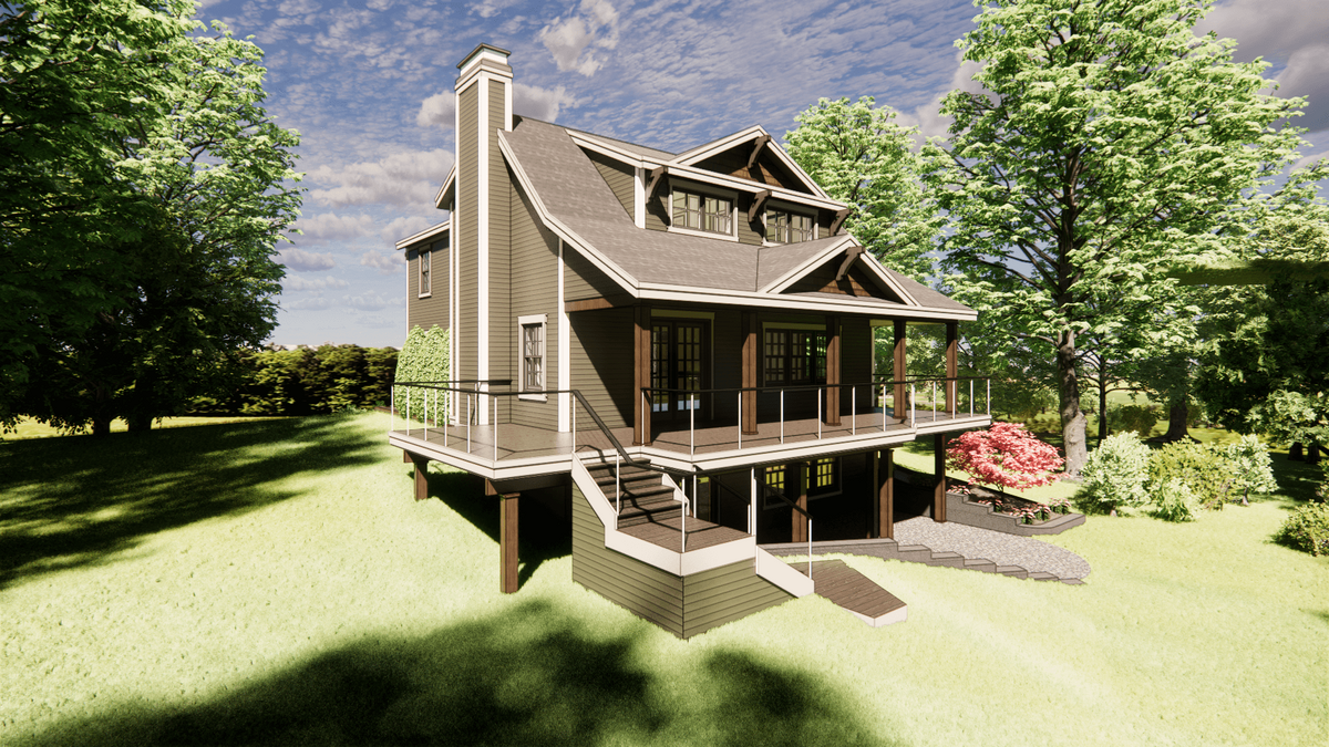 A modern two-story house with a wraparound balcony, elevated on stilts. Surrounded by trees and a bright blue sky, it has a staircase leading to the entrance and a small garden on one side with pink flowers.