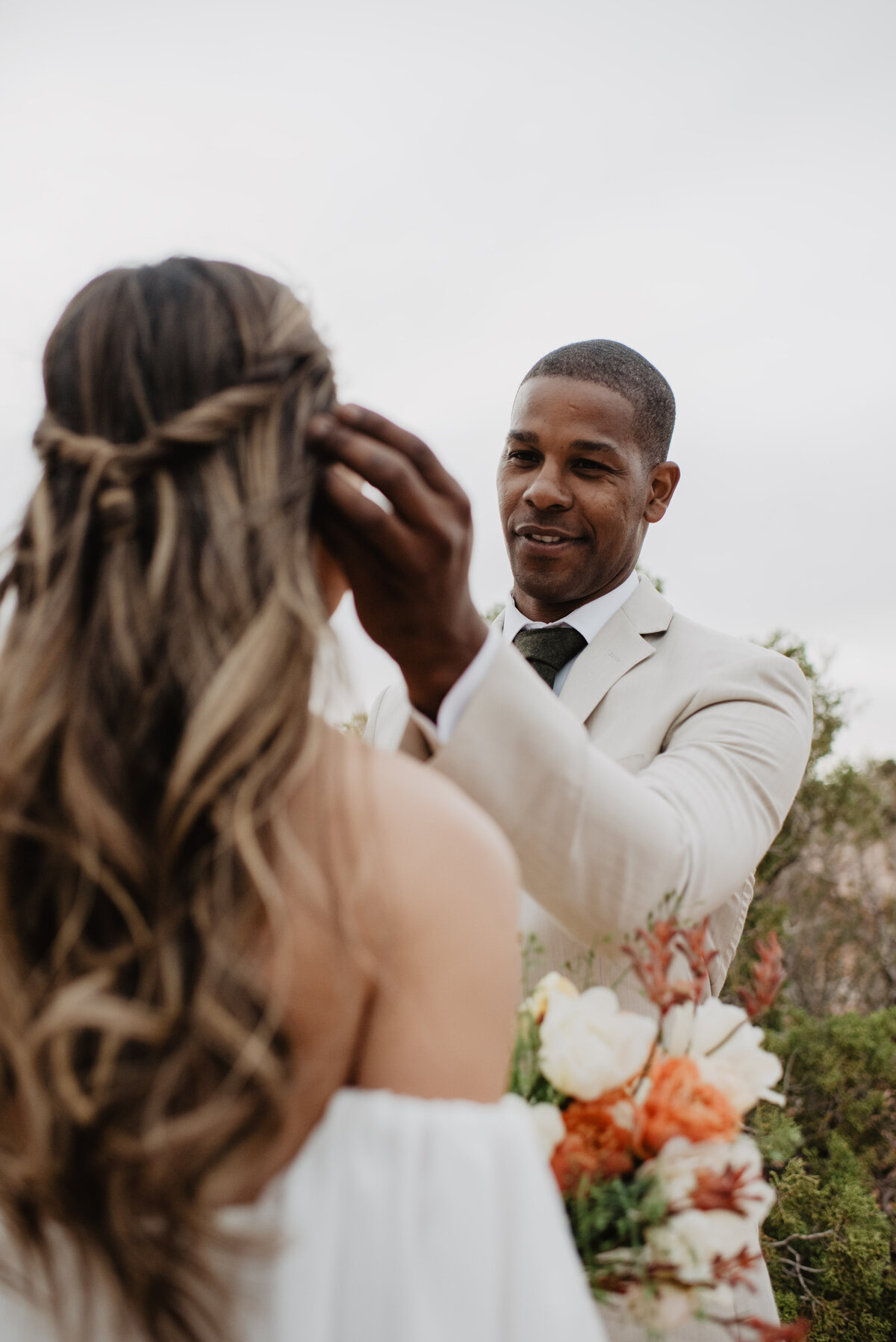 Utah Elopement Photographer captures groom putting hair behind woman's ear