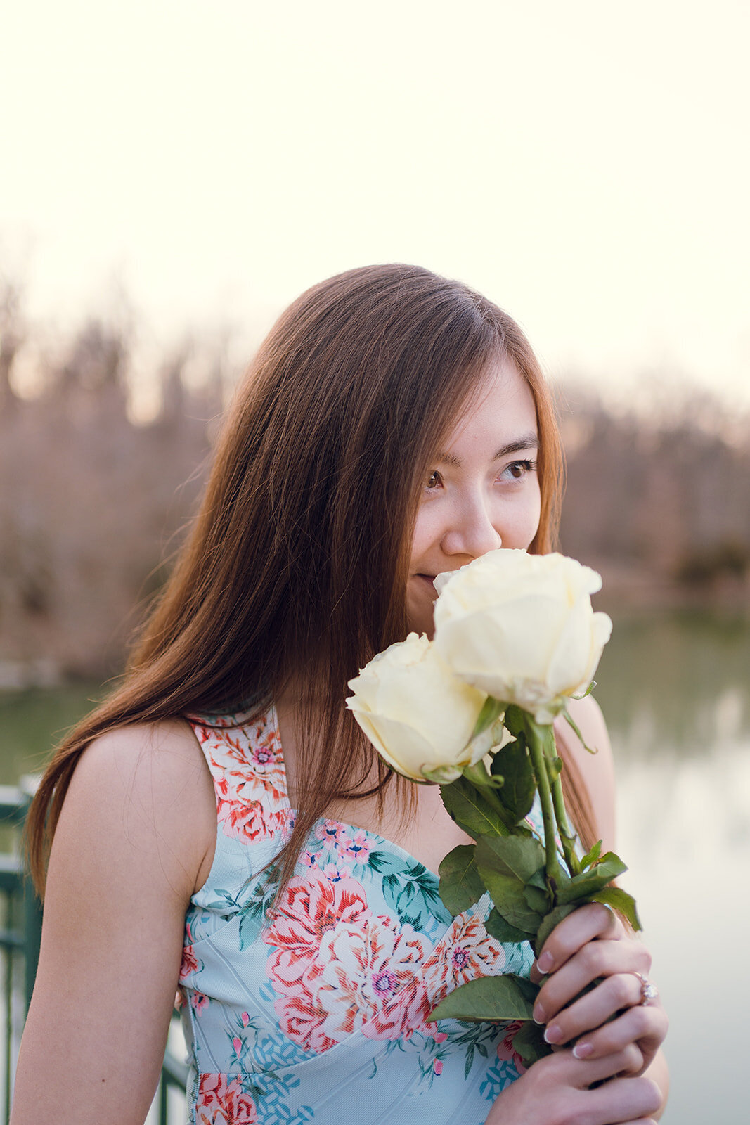newly engaged woman holding flowers looking at fiance