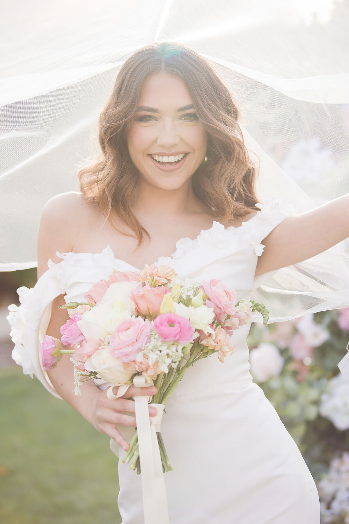 joyful smiling bride under her veil at reverie manor gardens in las vegas nevada