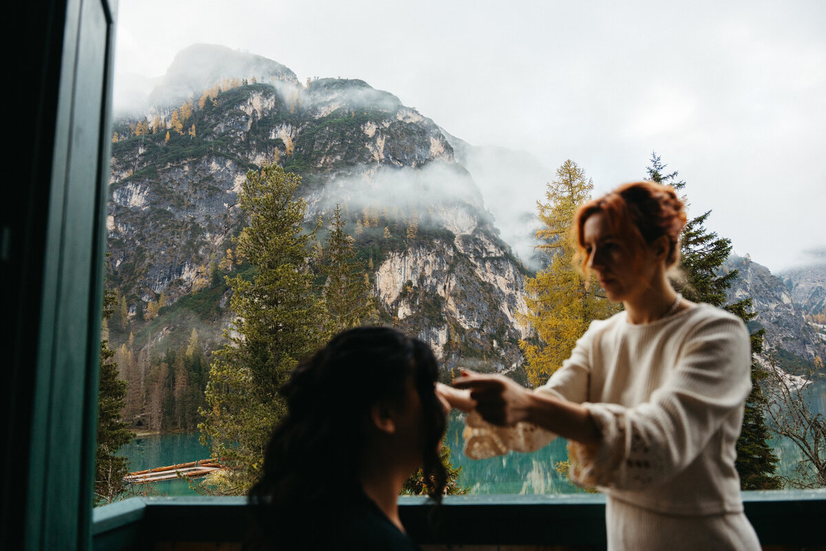 Bride having hair styled with mountain views behind her