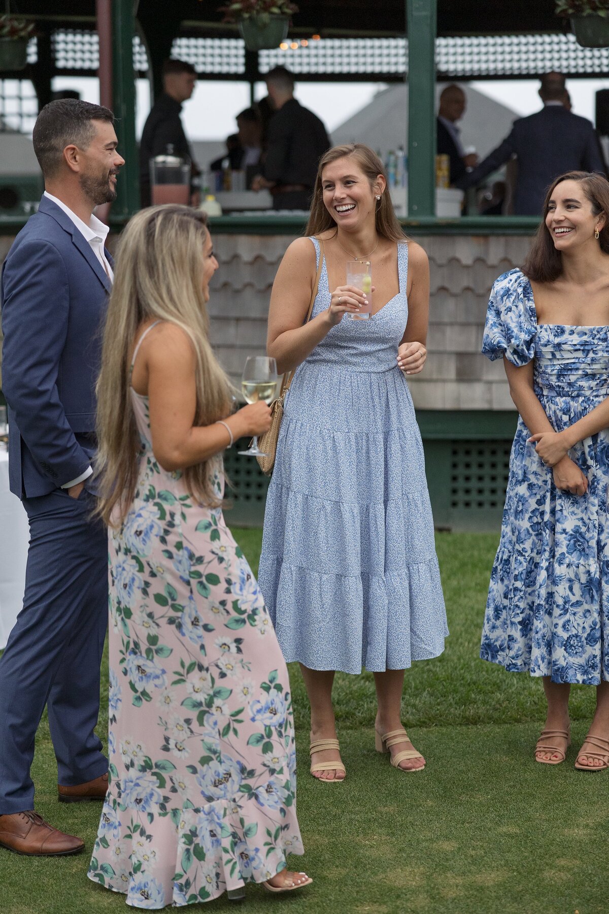 Guests mingle on the lawn of the Tennis Hall of Fame  in Newport during a welcome party. 