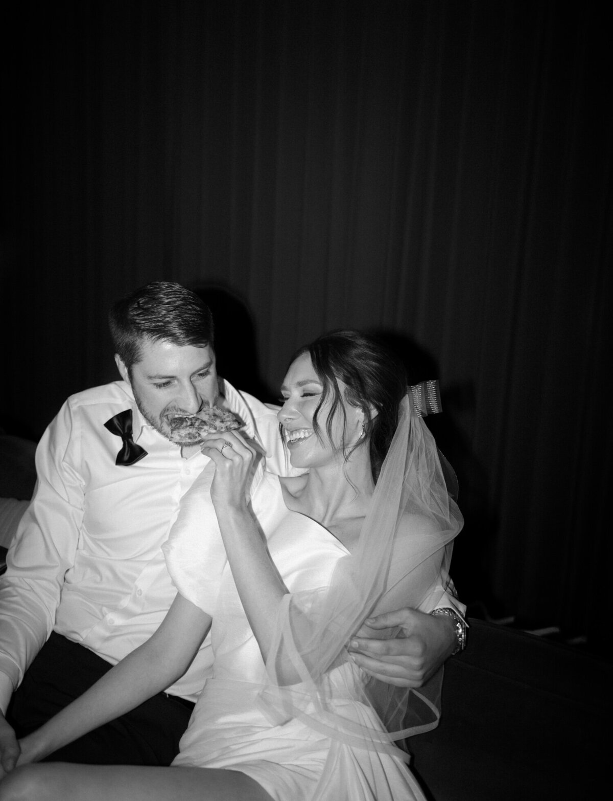 playful couple shares pizza after wedding, Shinola Hotel