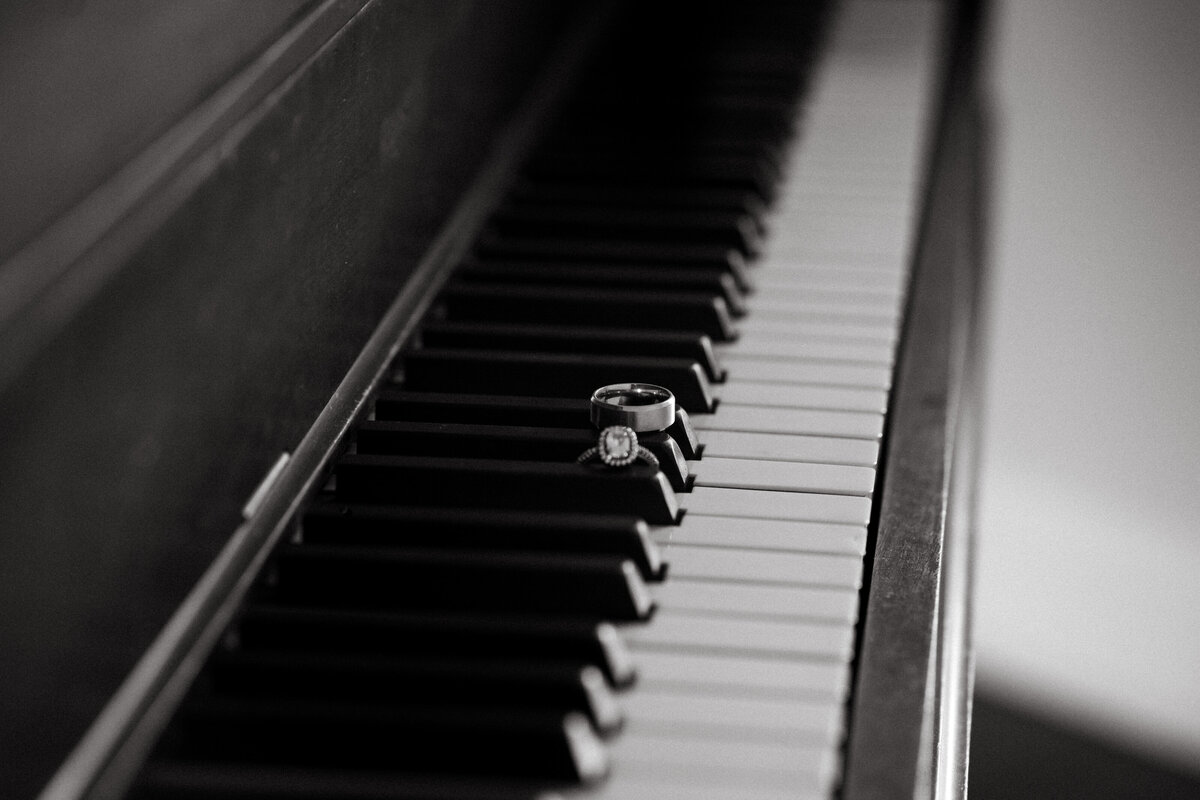 Wedding rings sit on piano keys