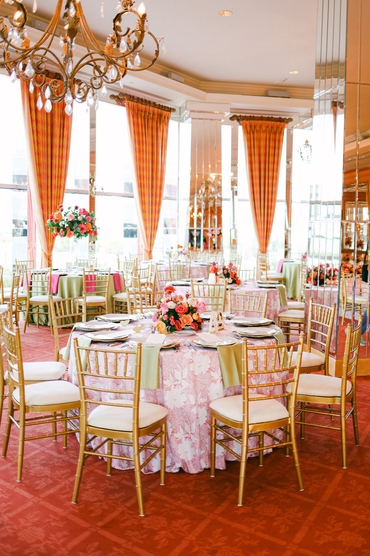 A wedding day photo of the reception room that is decorated in a pink theme
