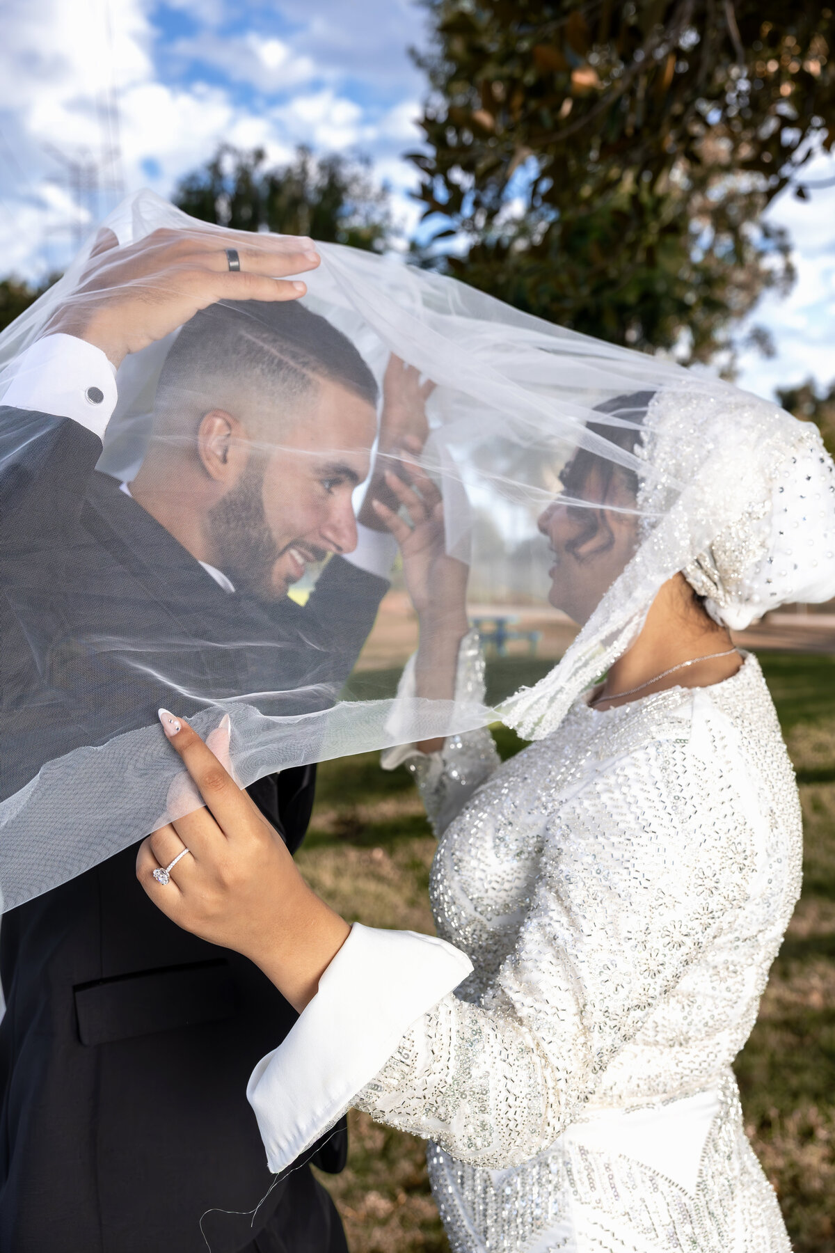 Arabian Bride and Groom Laughing Under Bridal Veil – Los Angeles Wedding Portrait