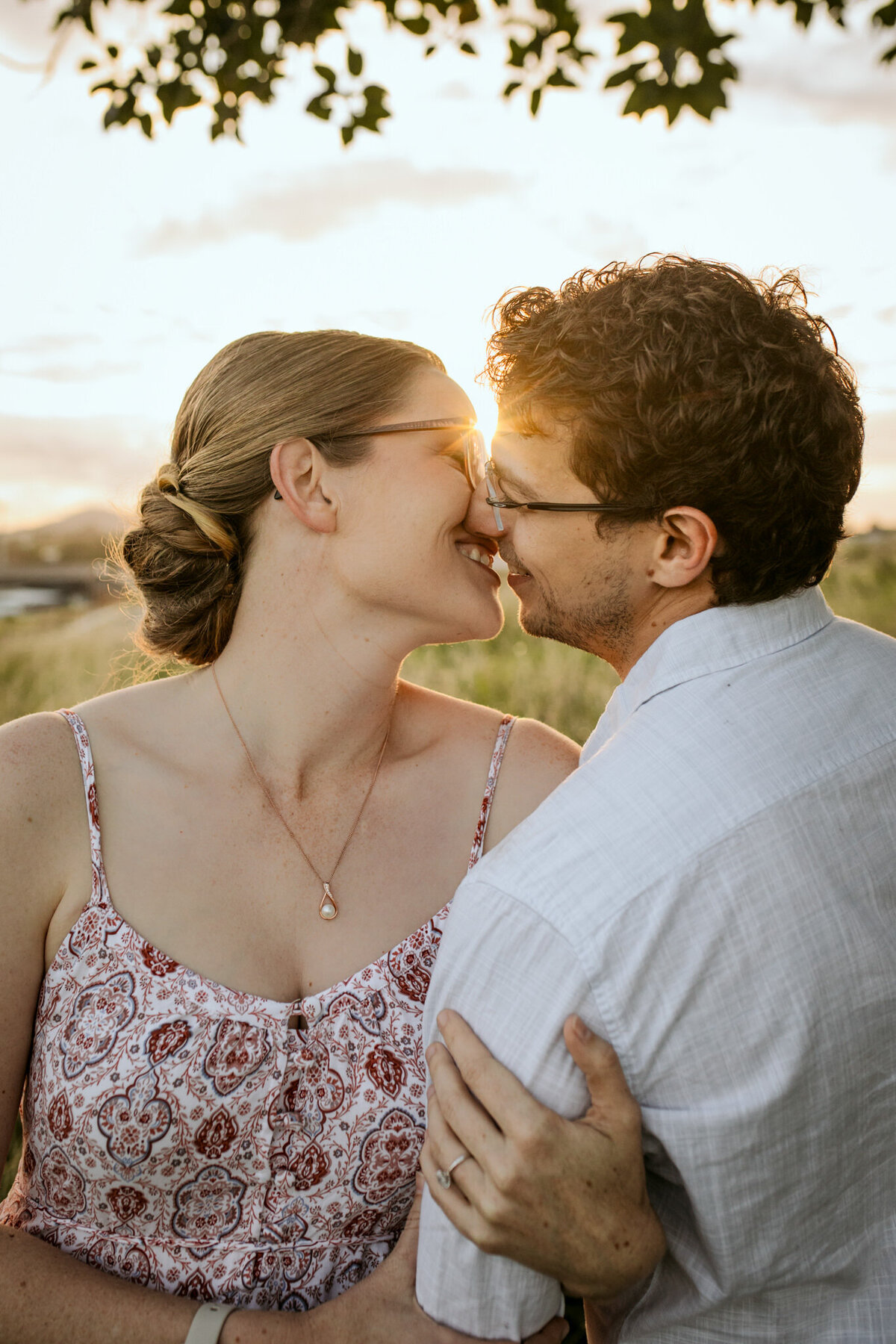 A romantic Sunset kiss between a couple in a park. 