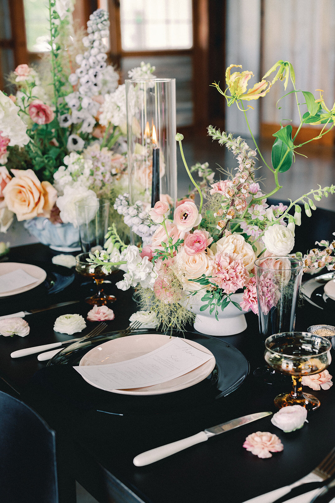 Table setting with menus and pink and green floral centerpieces