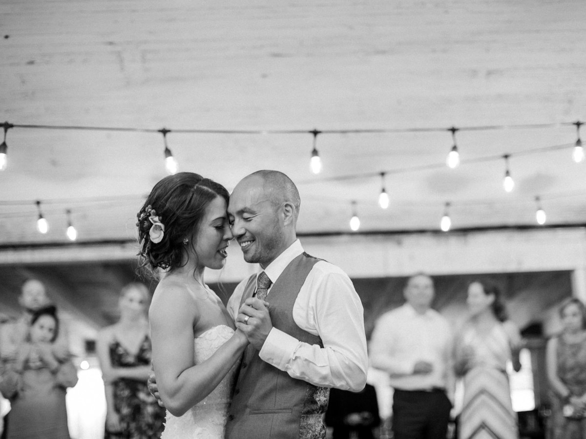Black and white wedding photos first dance string lights © Bonnie Sen Photography