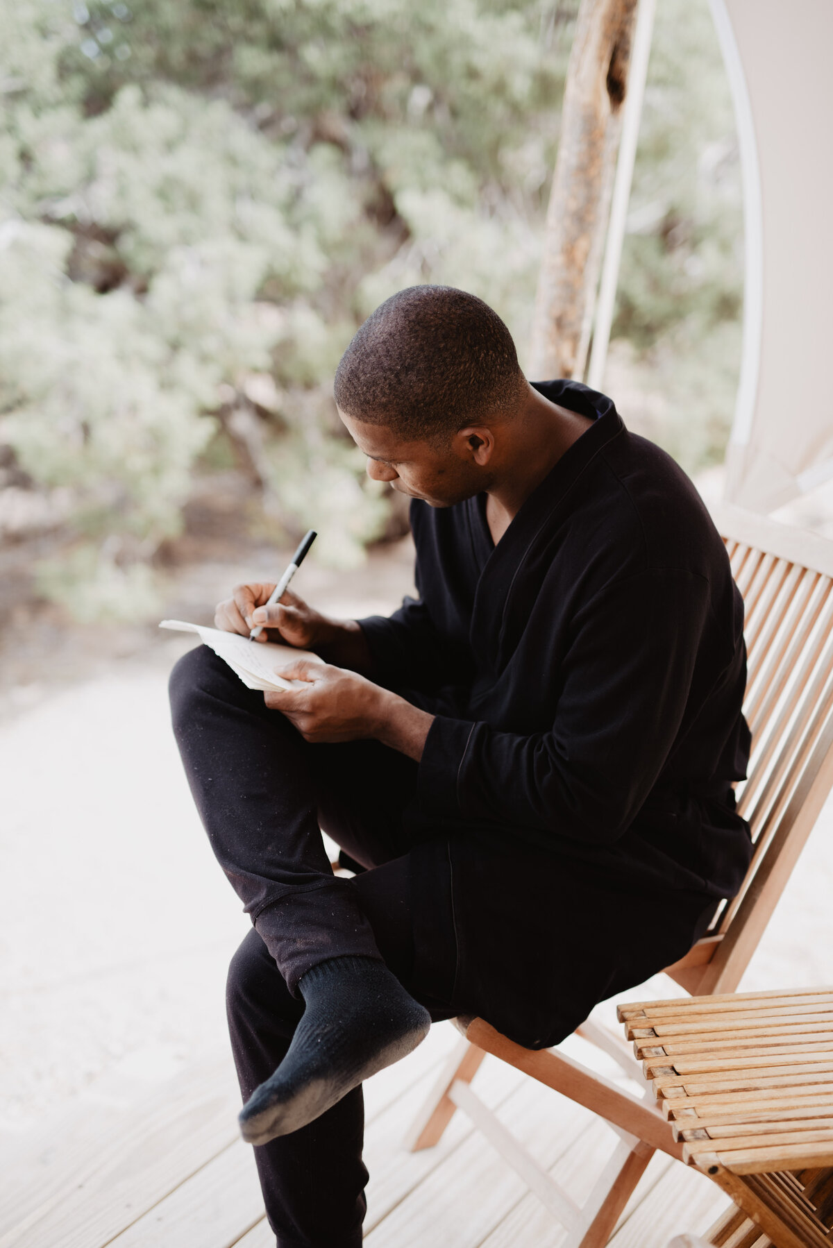 Utah Elopement Photographer captures man writing vows before Moab Utah elopement