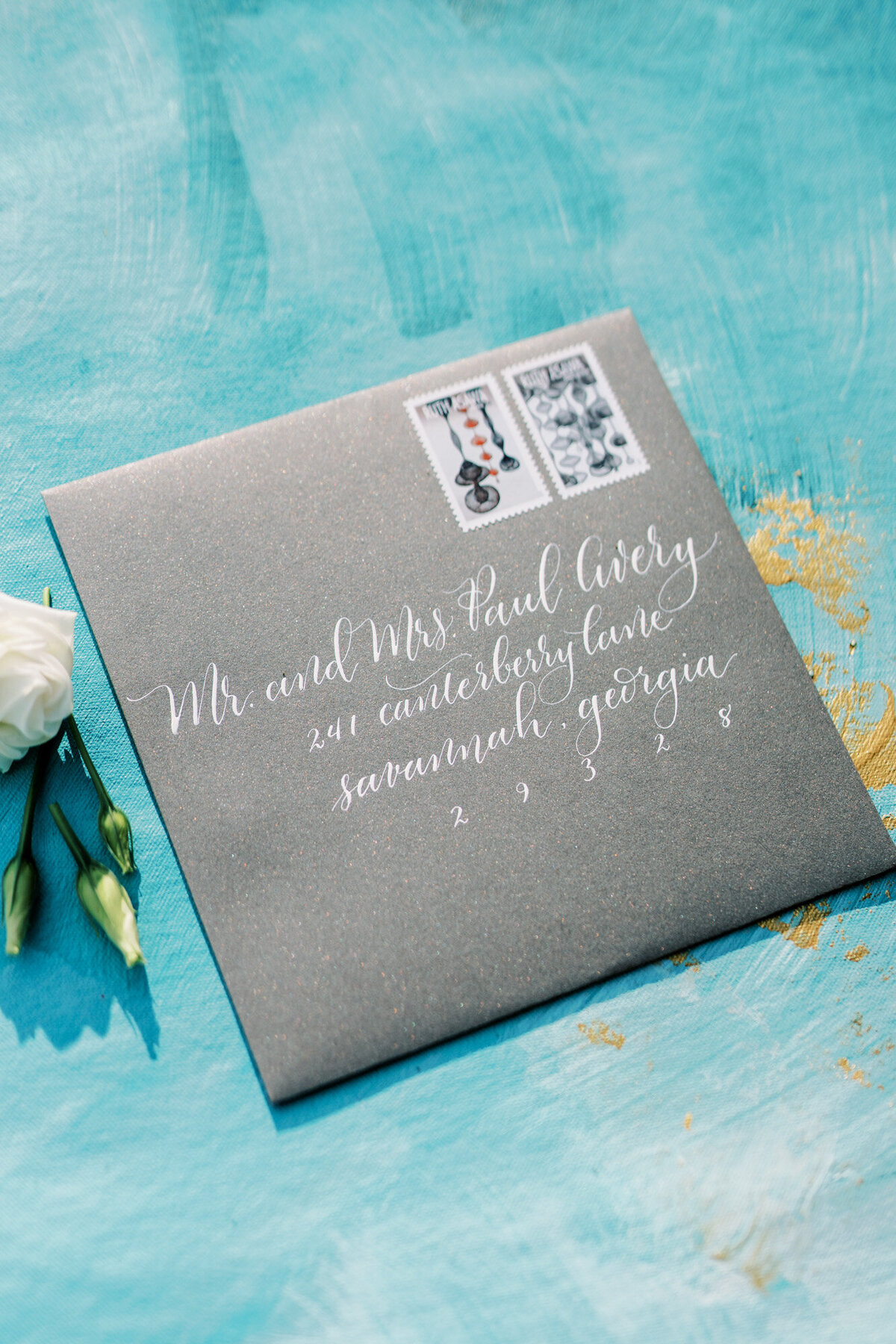 Black envelope with custom calligraphy with stamps