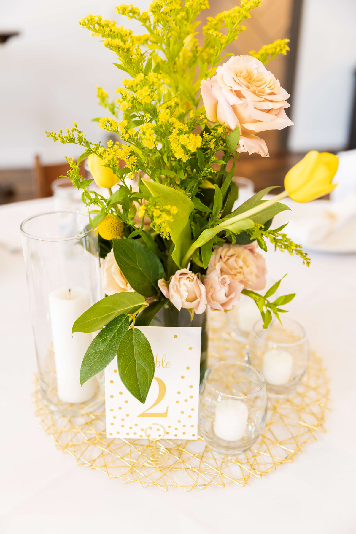 Wedding table centerpiece with florals and candles at Fat Bottom Brewery wedding in Nashville, TN