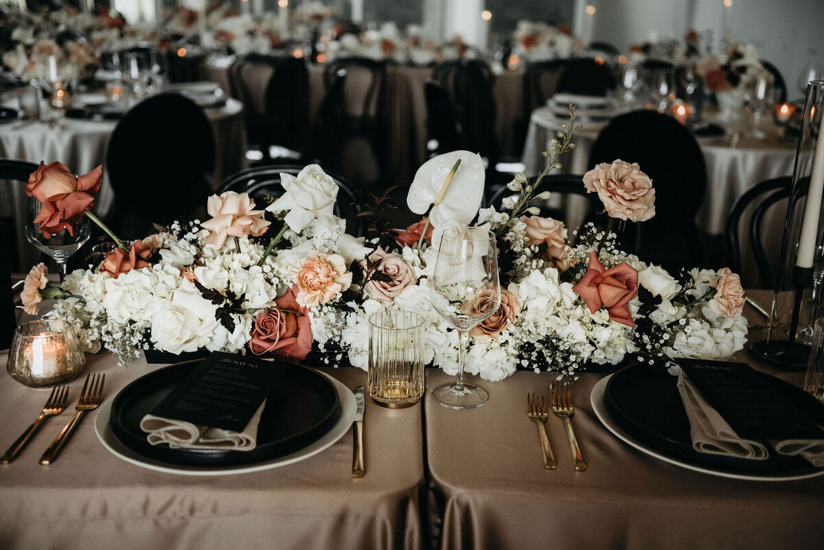 Wedding reception with a focus on the pink and white floral centerpieces.