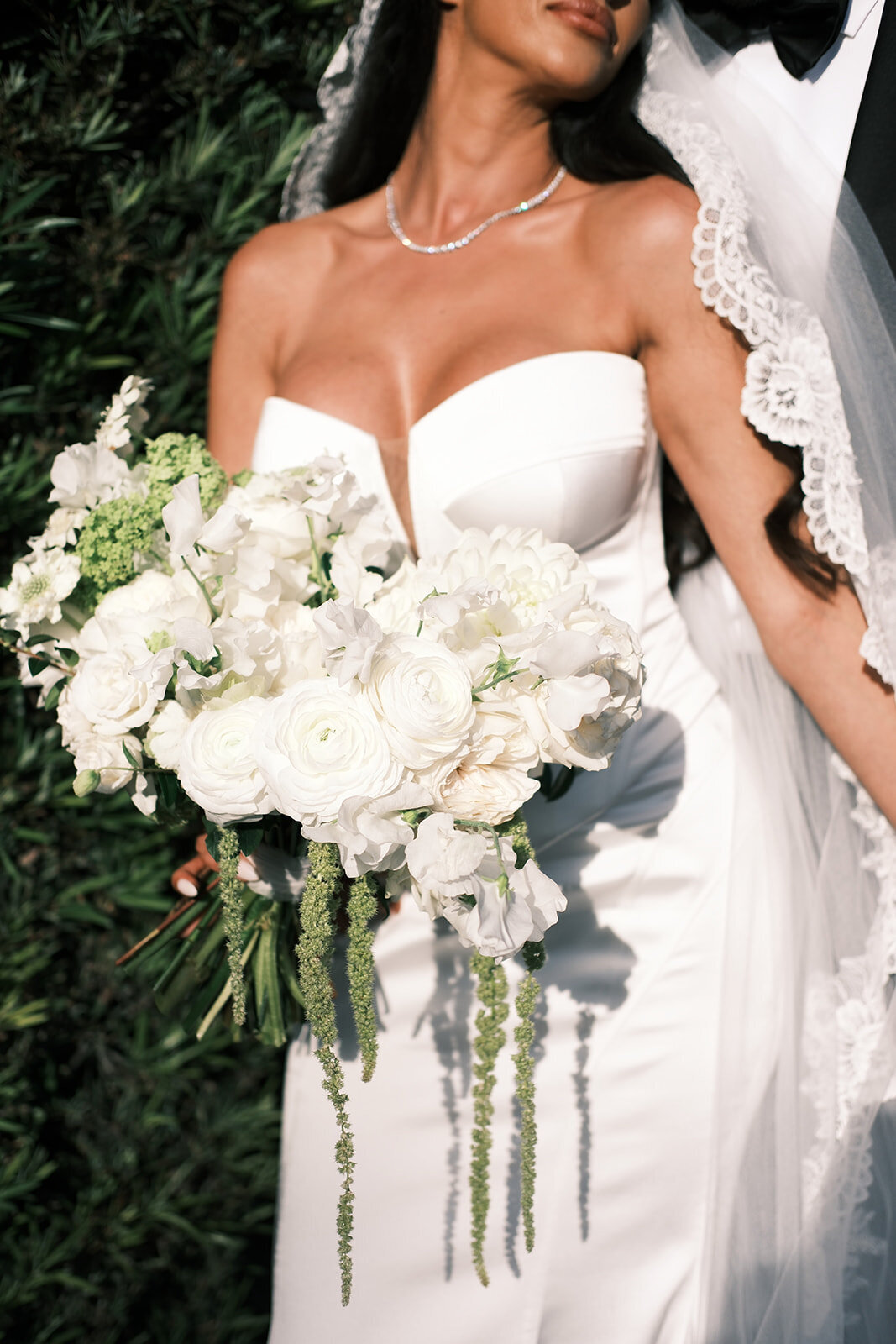 Artful, Italian-inspired bridal bouquet with hanging green amaranthus and petal heavy white blooms. Elegant and timeless floral design for Miami, Florida winter wedding. Destination floral design in Miami, Florida at Vizcaya Museum and Gardens. Design by Rosemary & Finch Floral Design in Nashville, TN.