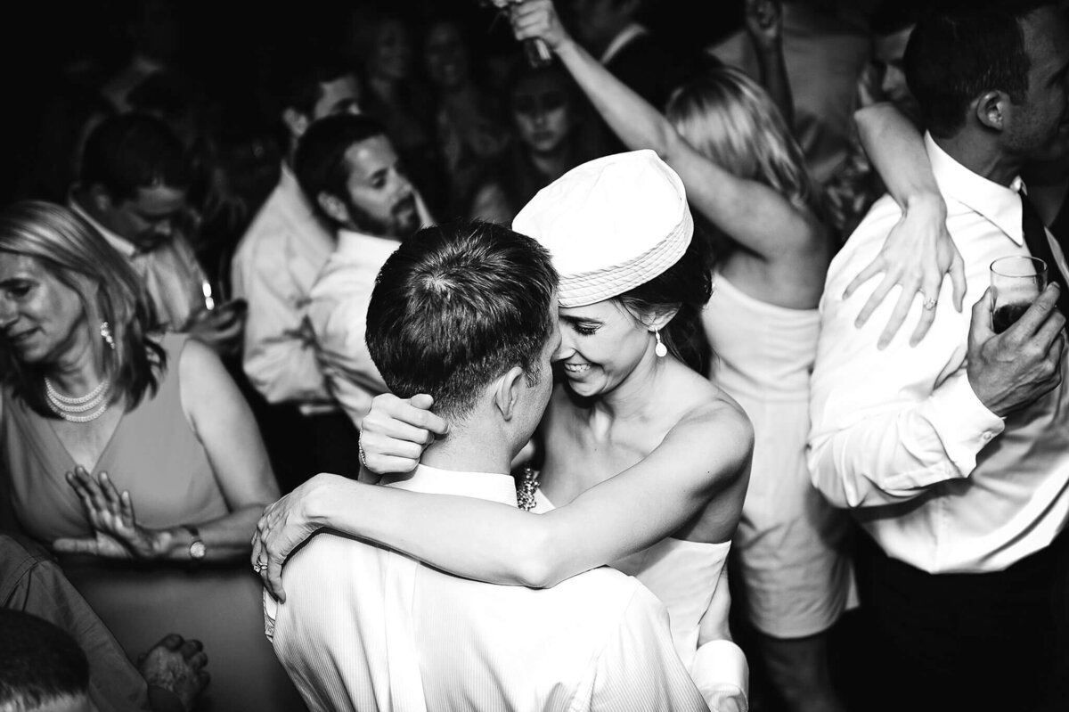 Bride with marine hat dancing with her groom and guests