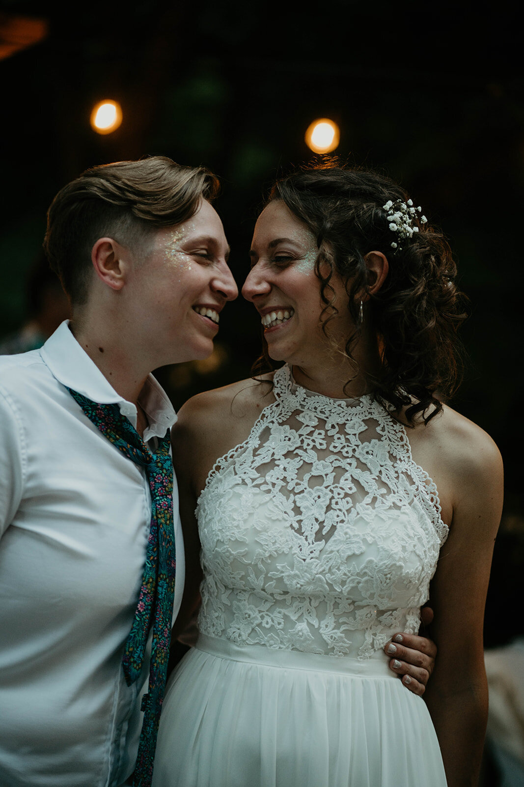 LGBTQ couple smiling at each other during their reception at Leach Botanical Garden