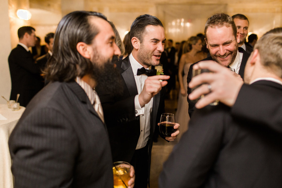 Gentlemen enjoy each other at this black tie cocktail hour at the Biltmore Ballrooms.  Luxury wedding photography by Rebecca Cerasani.