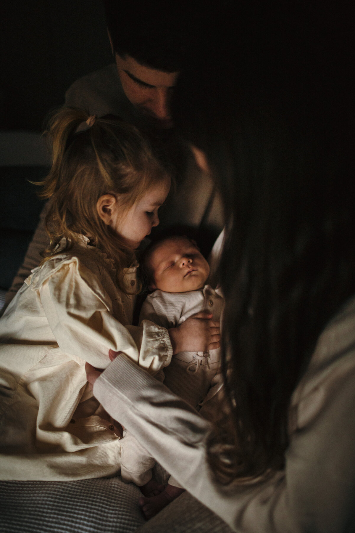 New baby cuddles with the family