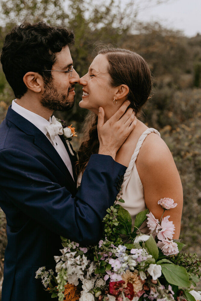 joyful-wedding-couple-nose-kiss-floral-bouquet-harvest-preserve-iowa-city-iowa-storyteller-collective-photo-co