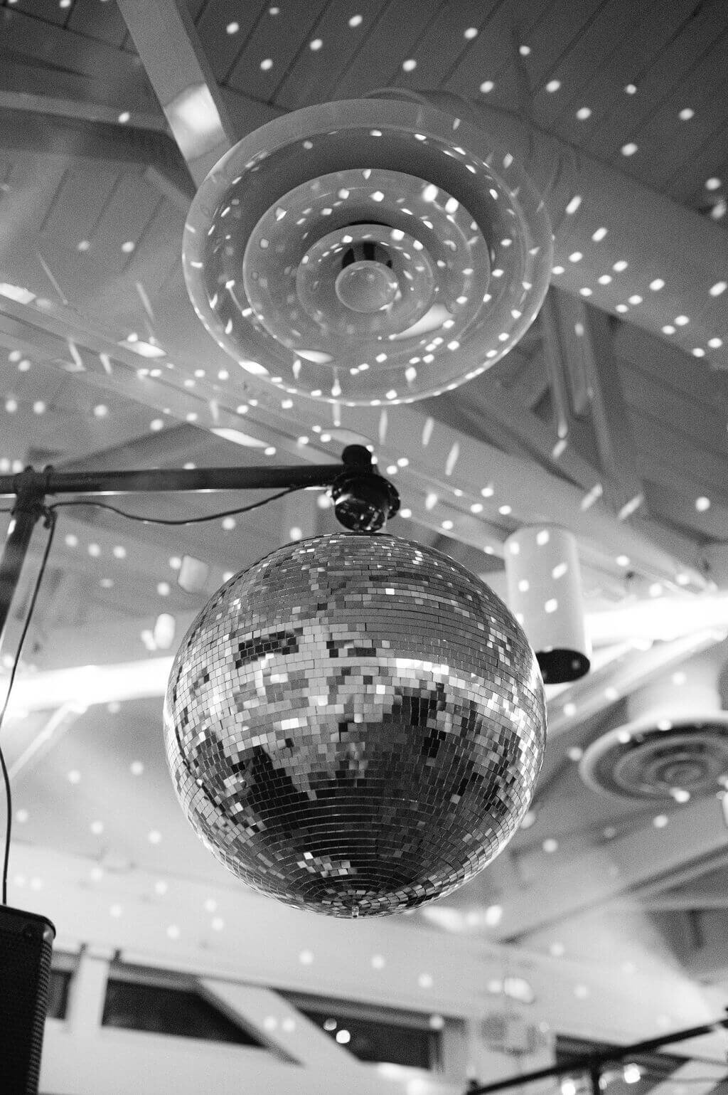 A disco ball reflecting off the ceiling at a DC wedding venue during the recpetion