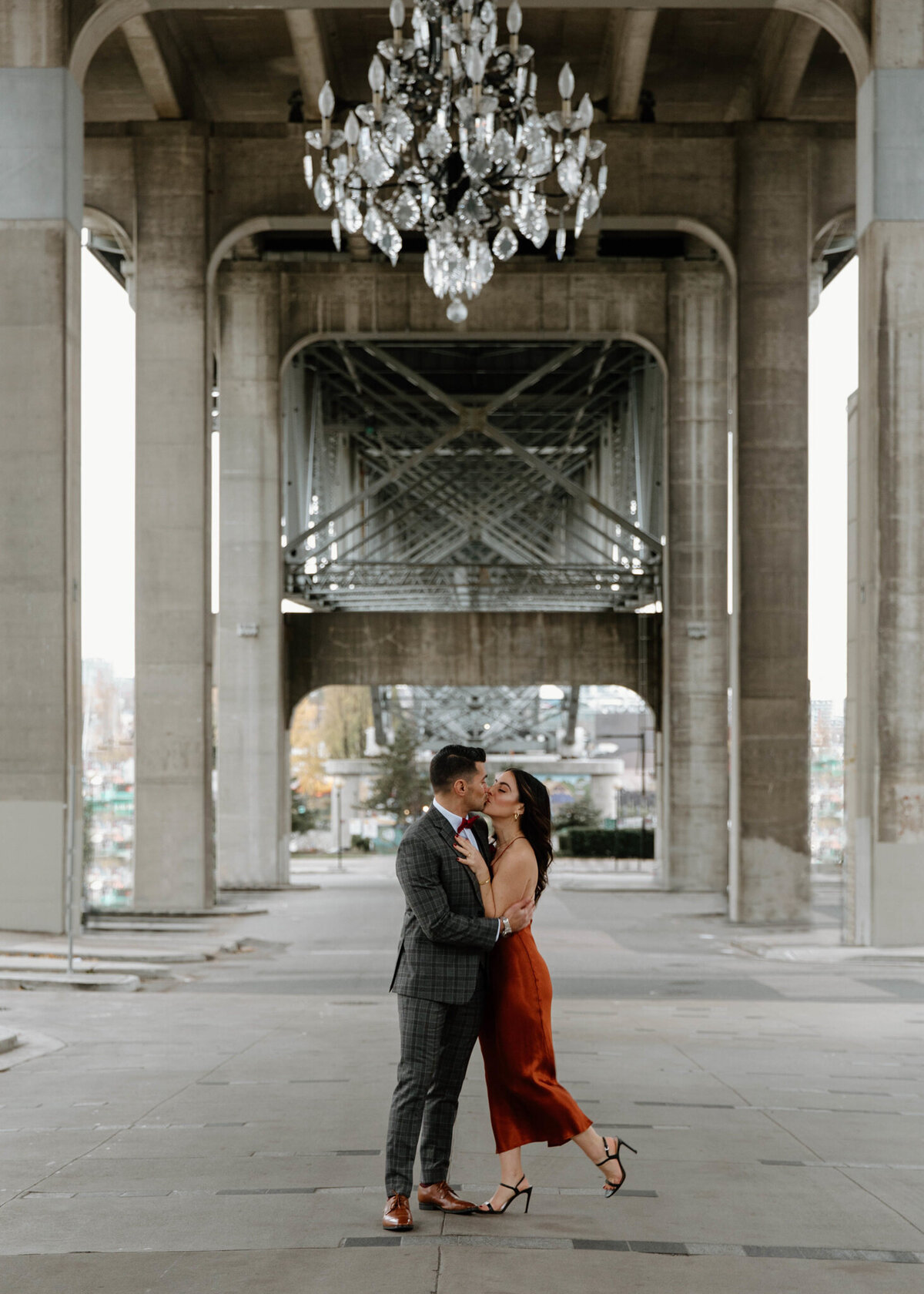 Stunning couple kissing under cement archway and crystal chandelier by Stunning bride and groom on beach, capture by Bronte Taylor Photography, is a Vancouver based photographer with a playful, genuine and intimate approach.