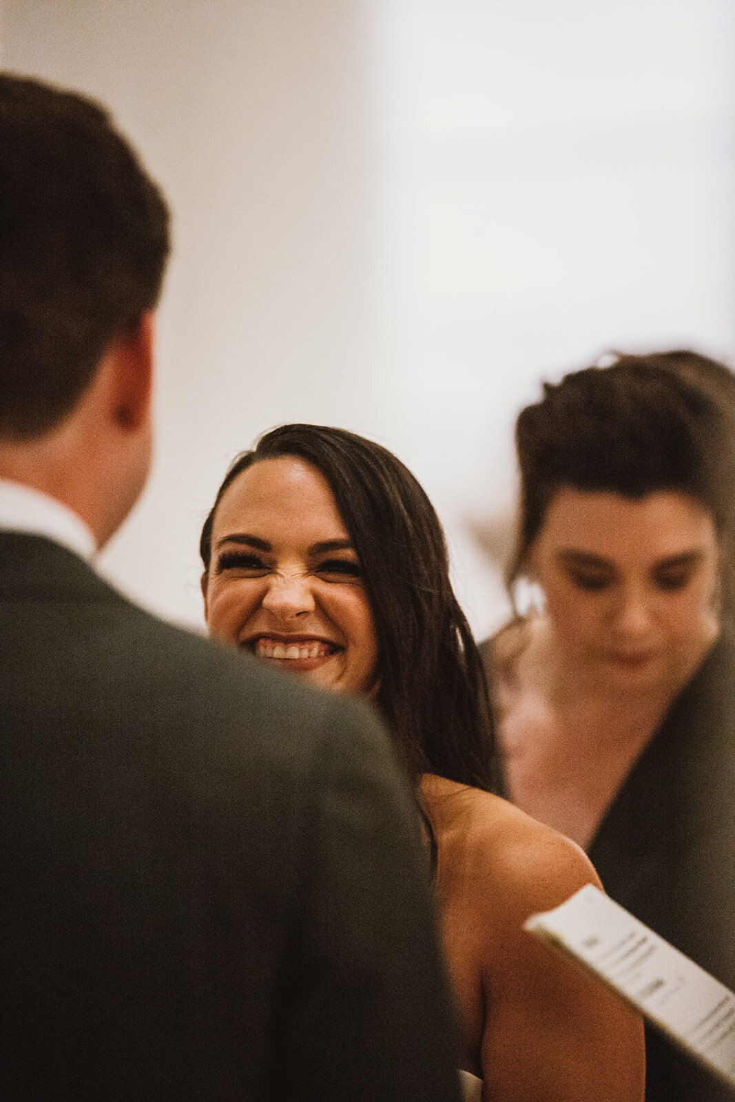 bride smiles at groom during wedding ceremony