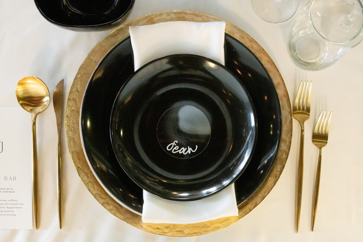 black and gold personalized plate setting