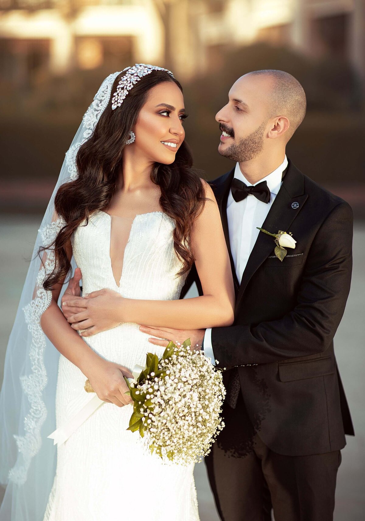 A Newlywed Couple Smiling at Each Other