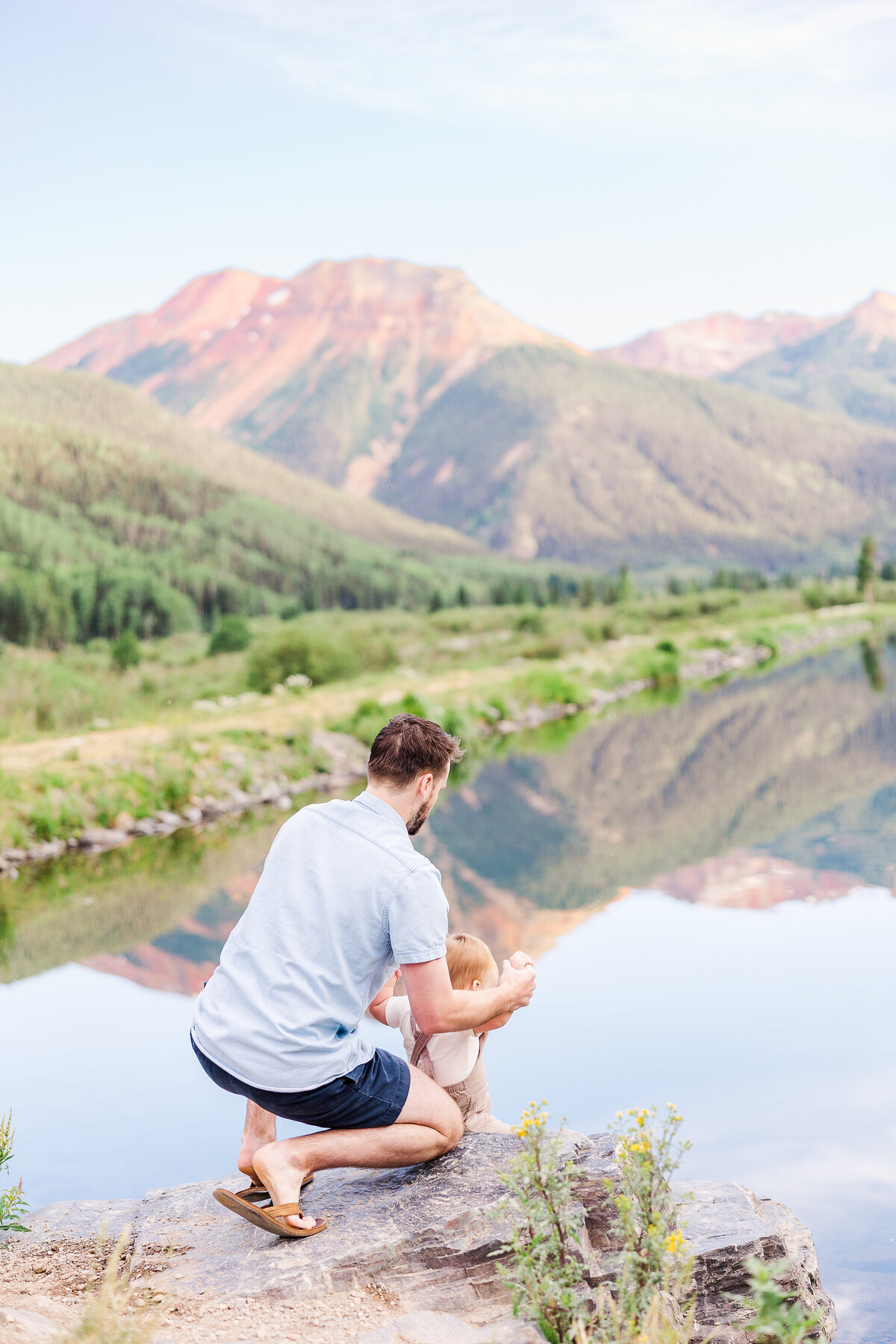 Father and son bonding over Crystal Lake at Red Mountain Pass in Ouray, CO during a heartfelt family session