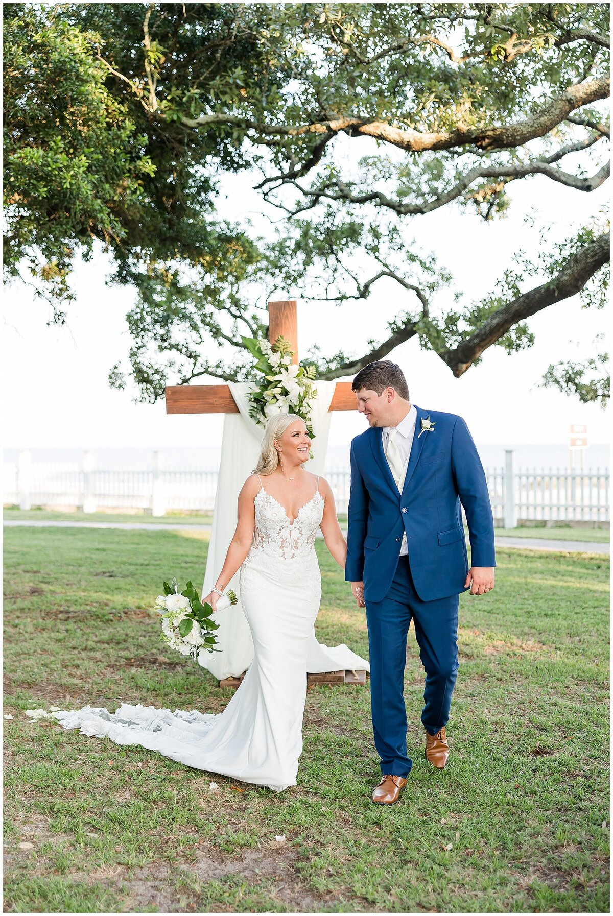 bride and groom portrait in front the cross on the beach