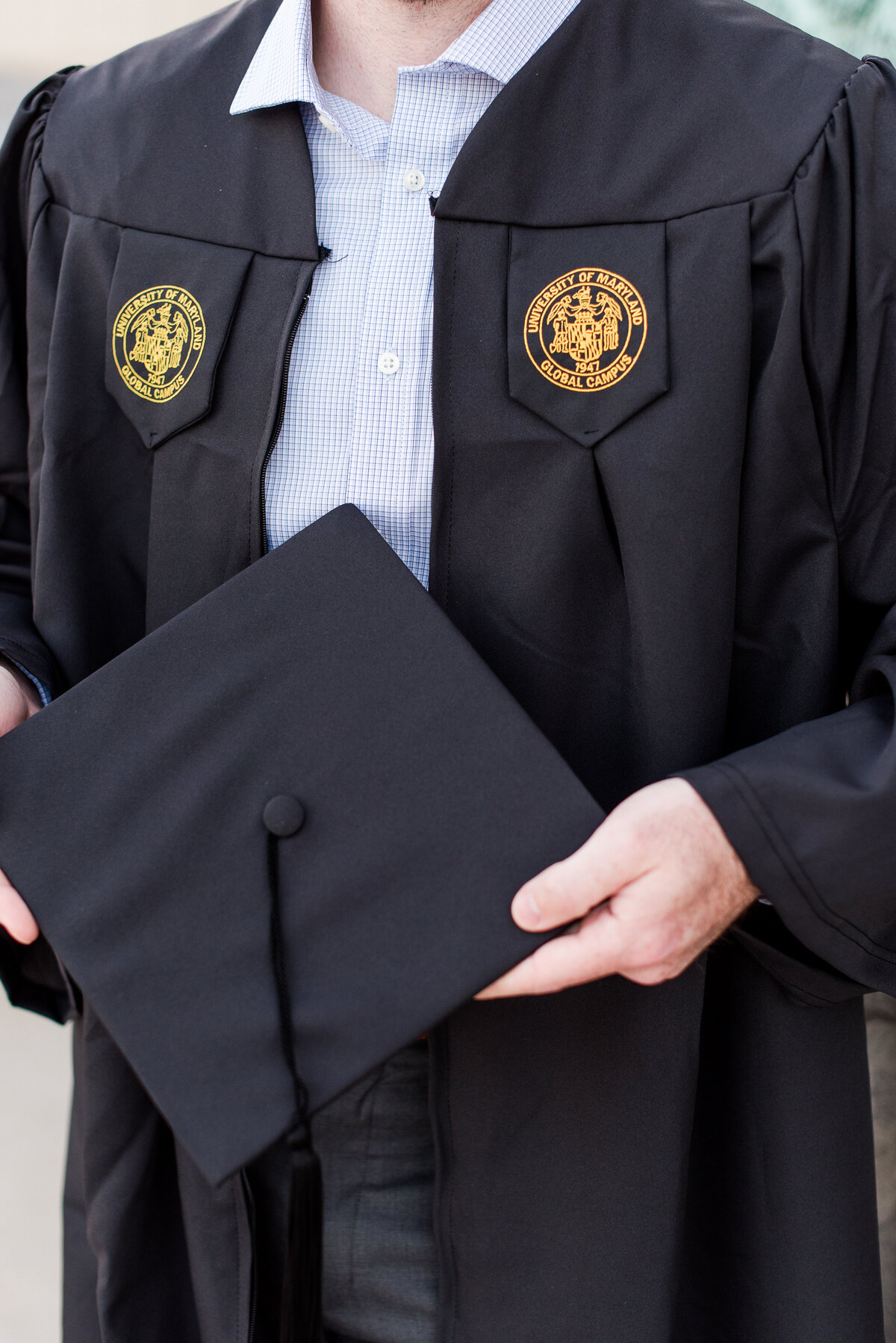 male law grad close up of hands holding cap