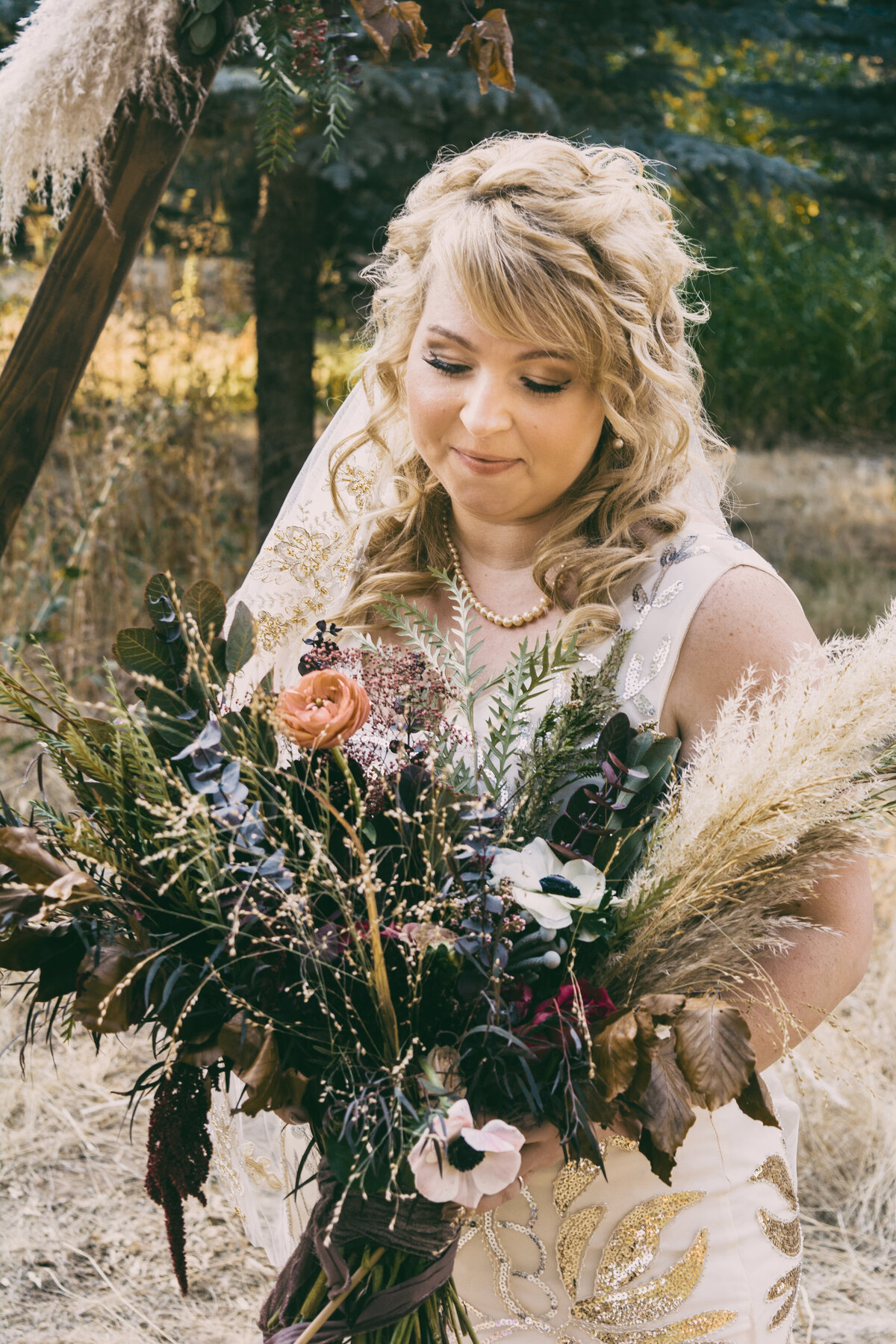 A romantic bride with a rustic bouquet, captured by 4Karma Studio. Bohemian wedding photography style