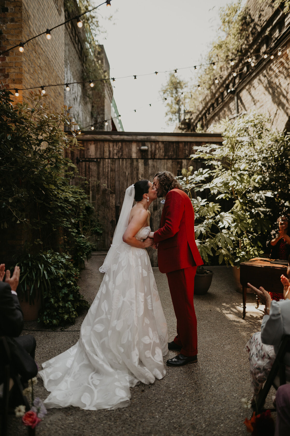 A bride and groom share their first kiss at their wedding ceremony at 100 Barrington. 