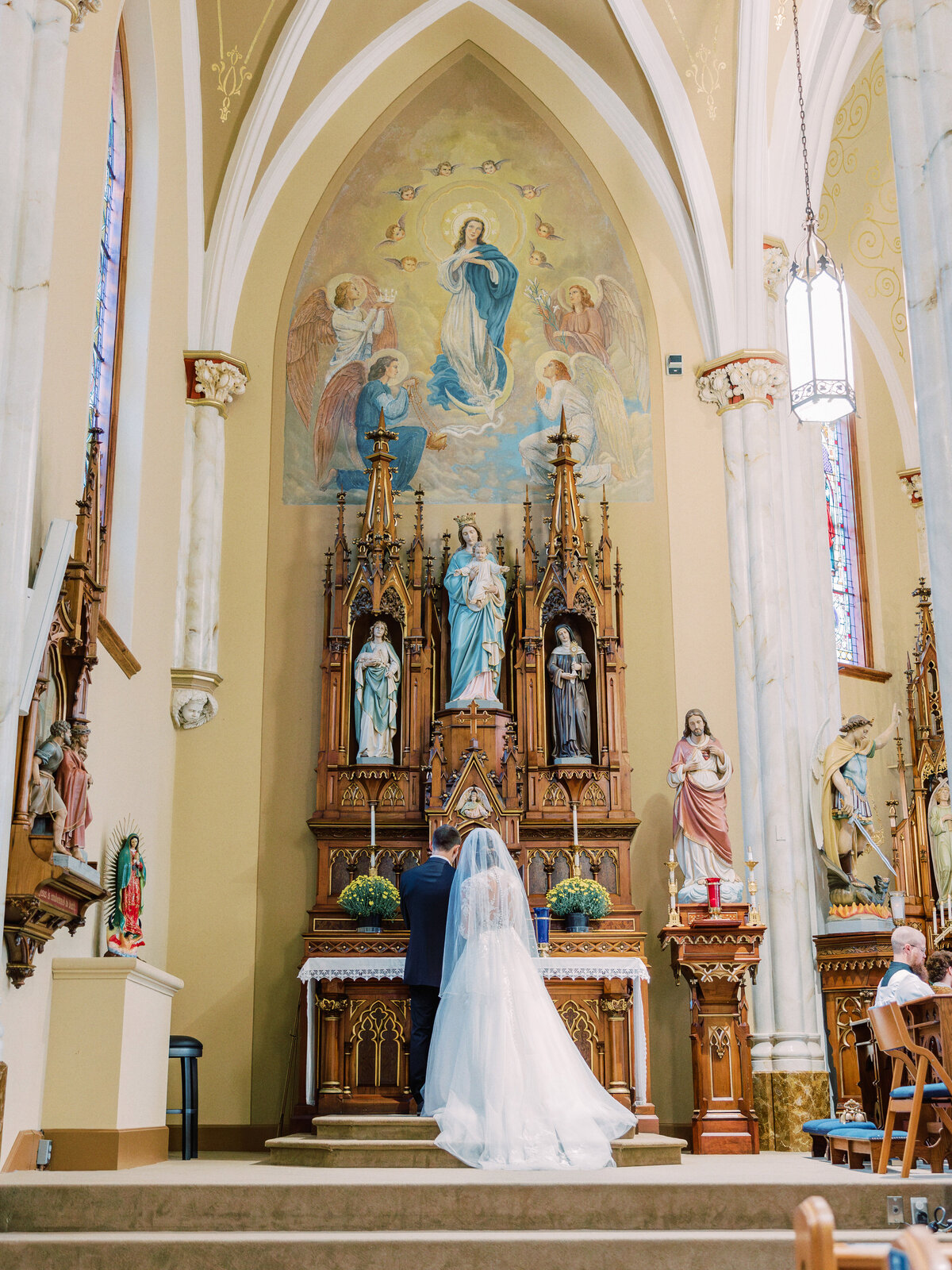 Bride and groom pray to Mary during wedding Mass at Holy Angels in Sidney, OH