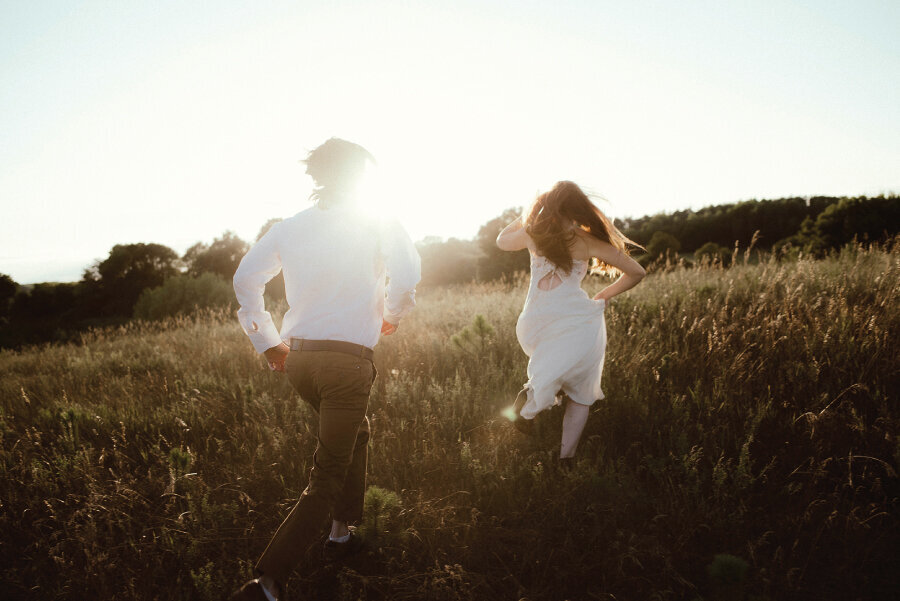 couple-running-through-field