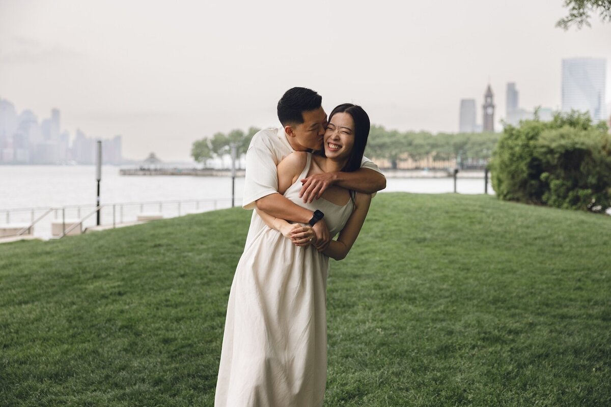 Couple laughing together on a rainy day at Hoboken waterfront