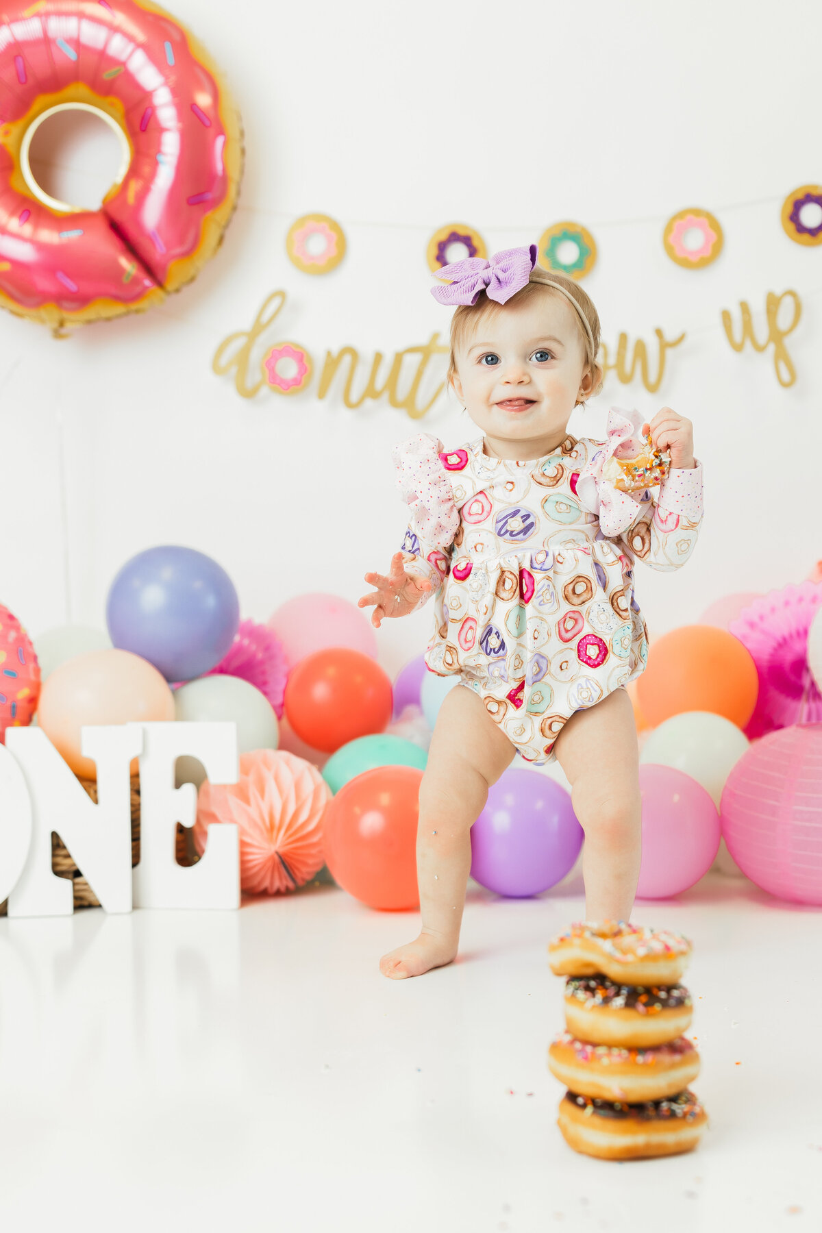 baby girl with a stack of donuts by harrisburg pa baby photographer