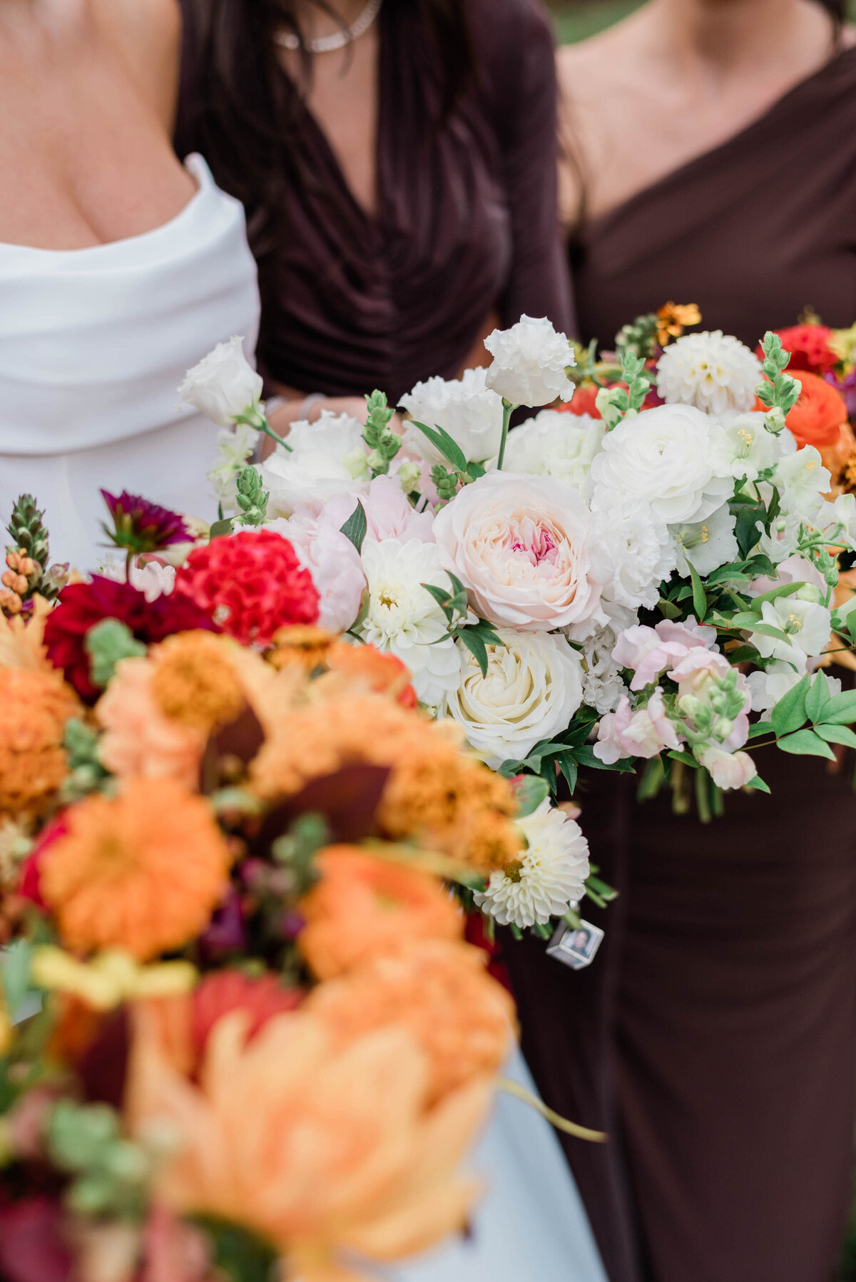 A close-up of wedding bouquets held by the bride and bridesmaid